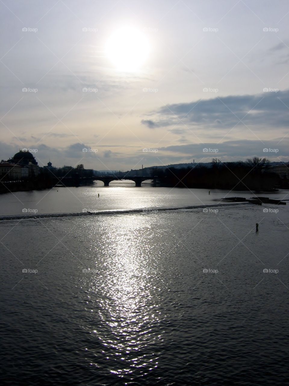 Sun and Vltava. River in Prague 