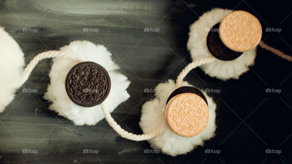 Cute and fun Oreo Cookie art photography contrasts of black and white with normal and thin Oreos on pompon puffs 