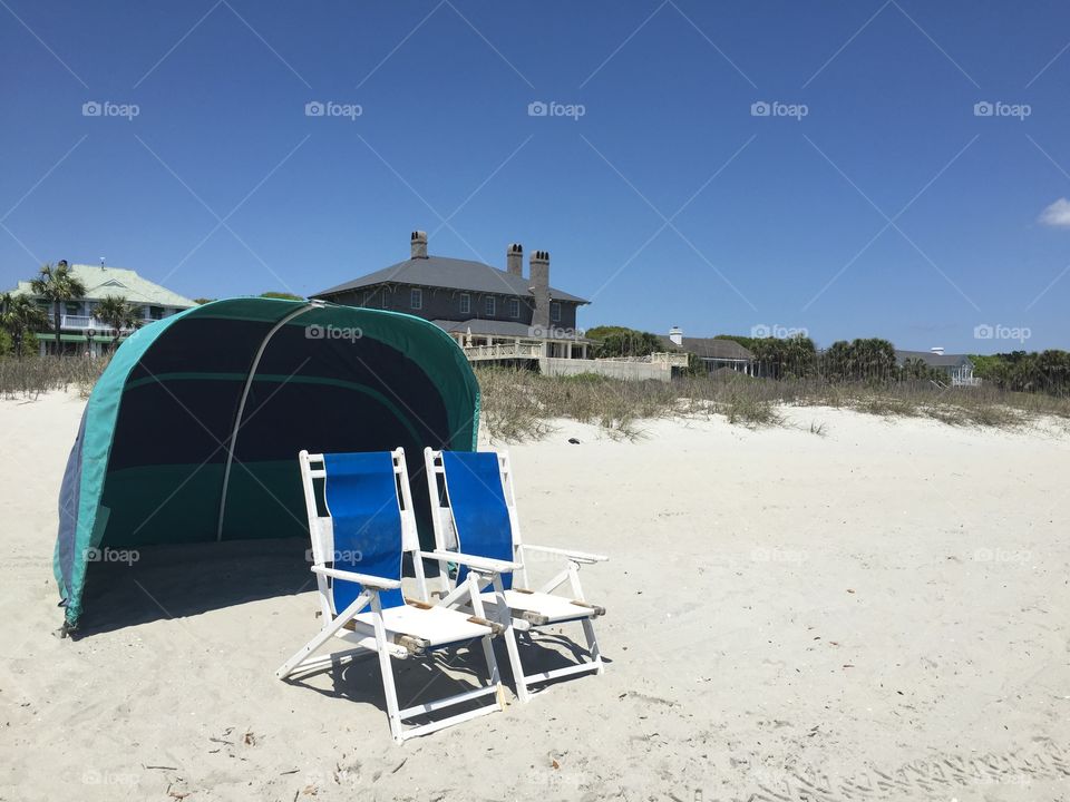 Beach scene. . Two beach chairs at the seashore 