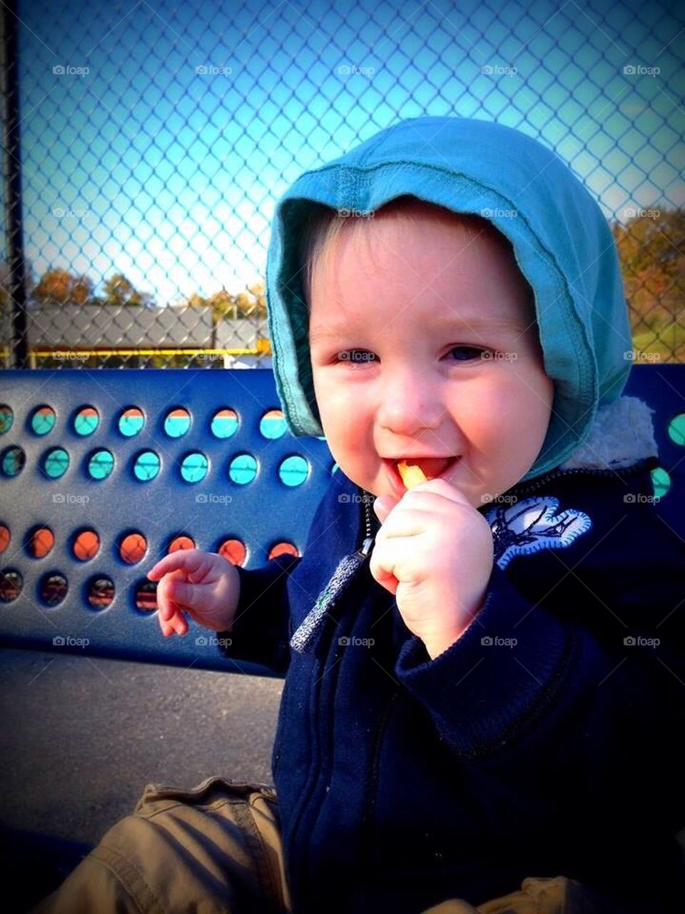 Happy baby eating a fry