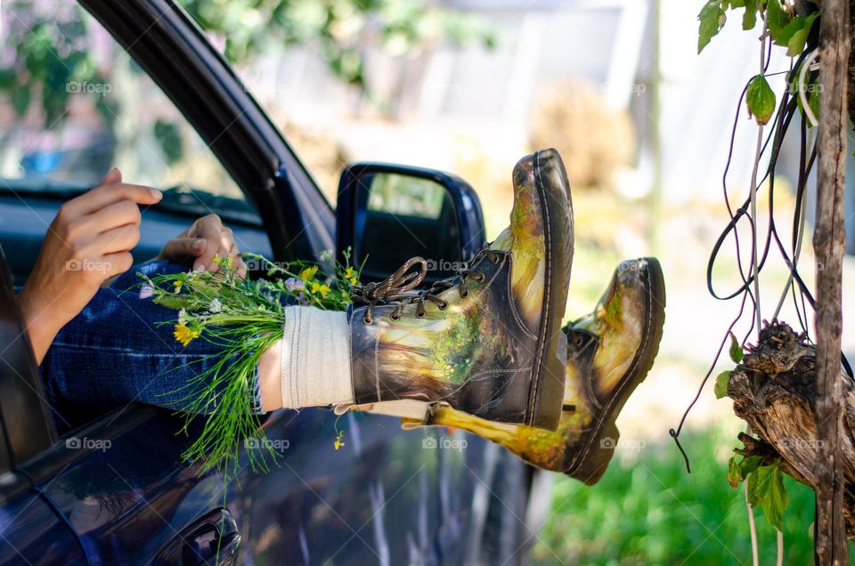 What's that doing here 😃? Woman Lying in Car With her Feet Out of Car Window. She Have Flowers Inside the Boots