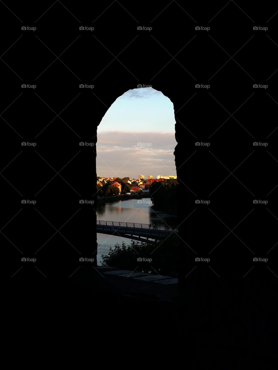 Silhouette of church wall in Görlitz, Germany  with view on Zgorzelec in Poland and the connecting bridge over river Neiße.