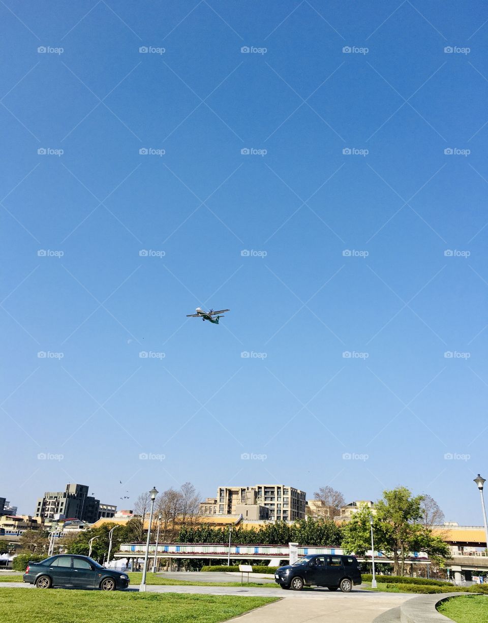 Catching Airplane flying above my head under the blue sky, located at Yuanshan District, Taipei 