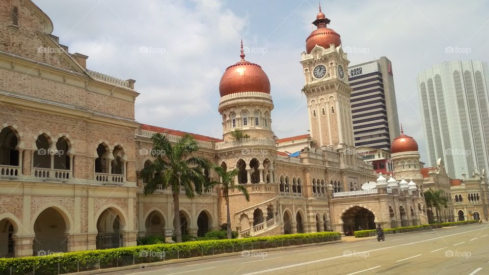 Under fair weather, walking along Malaysia's historical building of Sultan Abdul Samad.