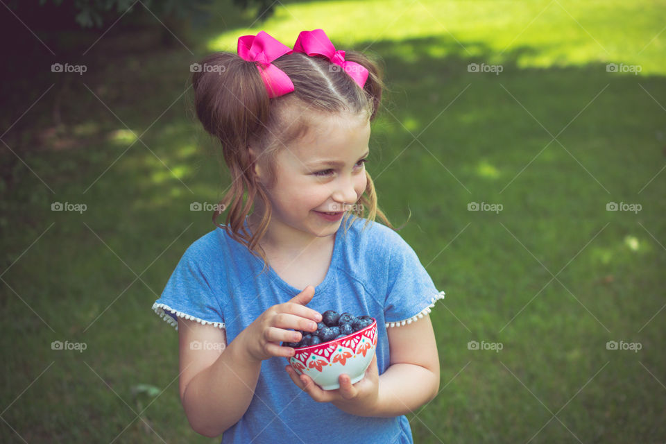 Young Girl with Pink Hairbows Eating Blueberries 21