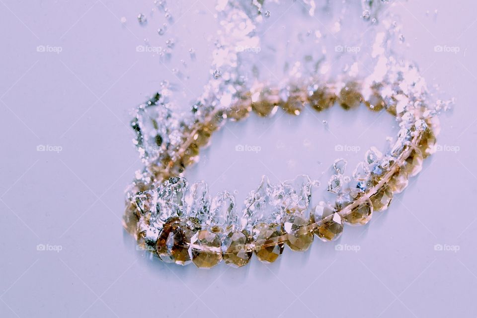 Splashing bracelet. High speed photography with jewellery 