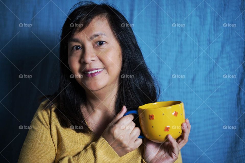 Portrait of a woman holding a cup