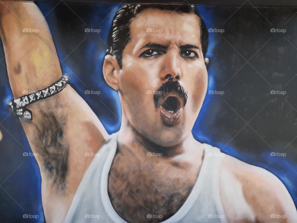 A close up photo of a mural depicting Freddy Mercury the lead singer of the band Queen.