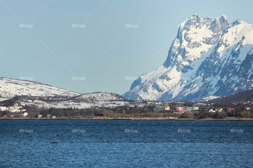 Norwegian giants. This is a typical Norwegian view. Small houses, buildings among giant mountains. This one is named "Skamtinden".