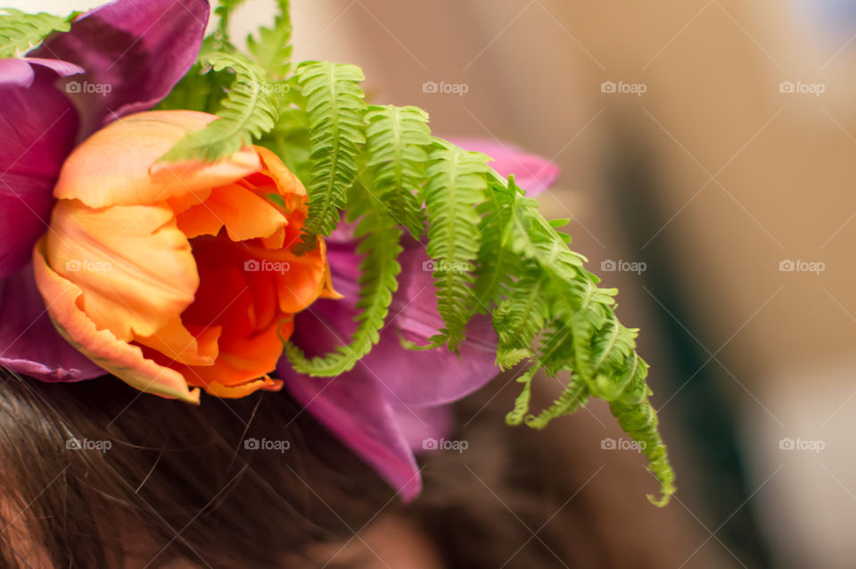 Wearing a flower garland in hair closeup detail of tulip and fern with red prince vine flower crown abstract photography 