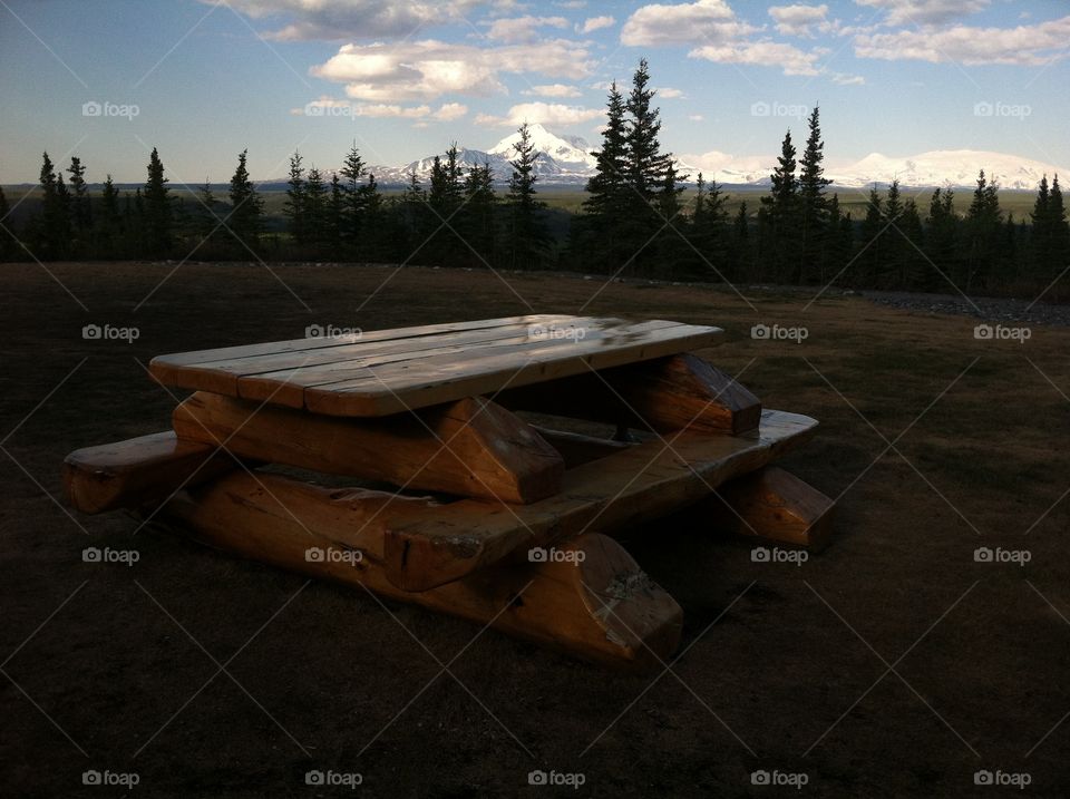 Alaskan picnic table with mountain background 