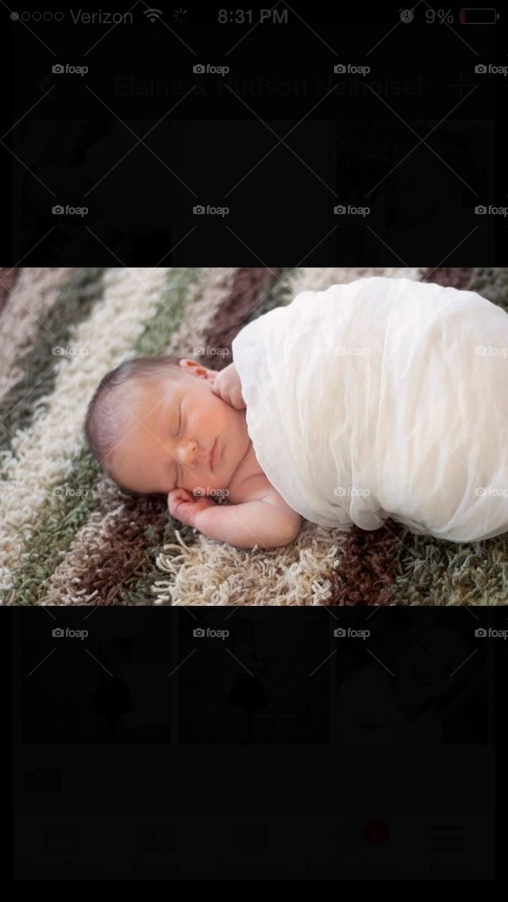 Newborn wrapped in Blanket Sleeping 