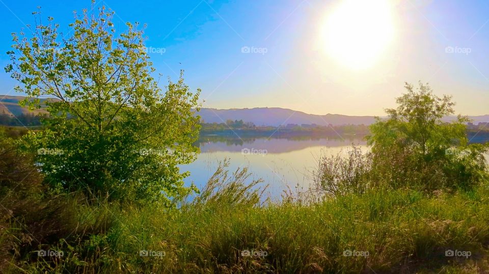 Scenic view of mountain and lake at sunrise