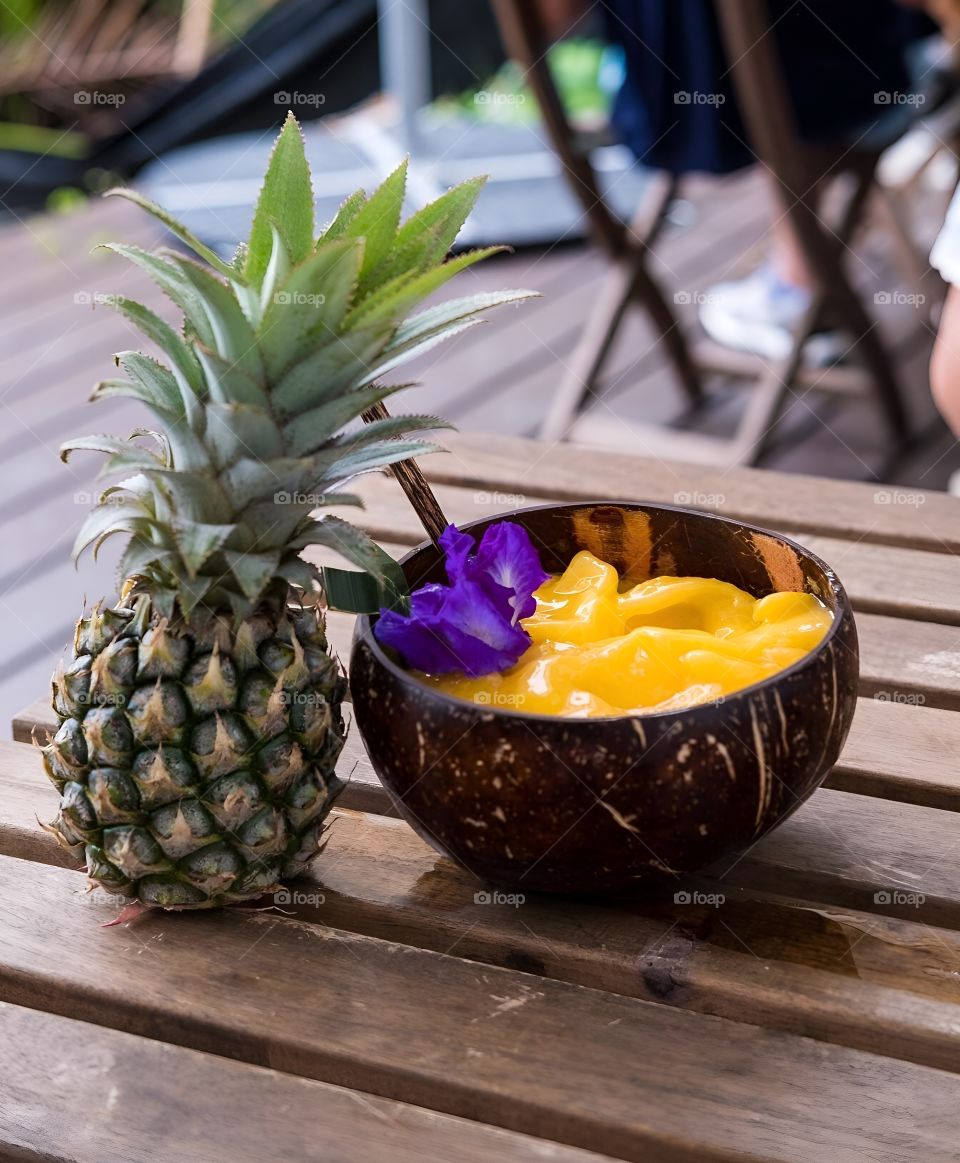 Mango smoothie garnished with pineapple rest time