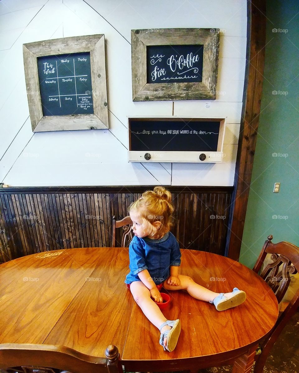 Girl sitting on table