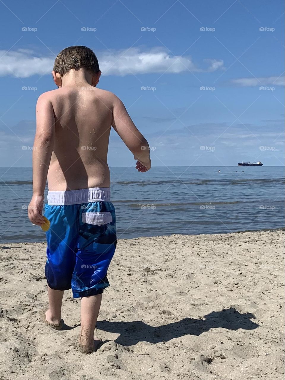 Little boy in blue at the beach 