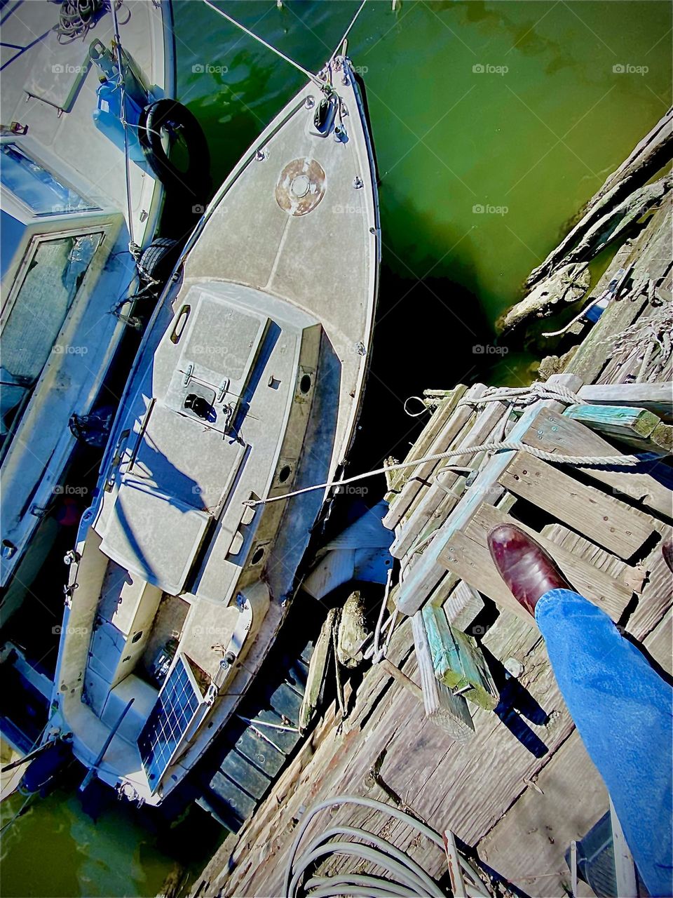 Two boats at Newtown Creek seen from the land at low tide. One is the “Salvation”, the boat on which we are staying, the other one belongs to someone else & is primarily used for storage. We walk over it to get to ours. 2022. Hypnotic Productions