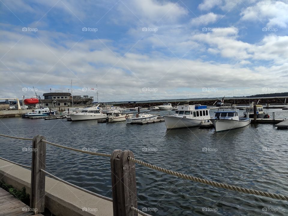 boats docked at the harbour in Summerside, PEI, Canada. scattered clouds.