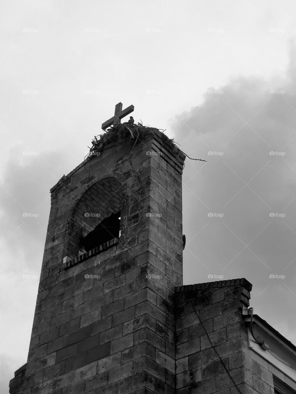 Osprey nest atop an old brick church steeple in Cedar Key. Low angle monochromatic view.
