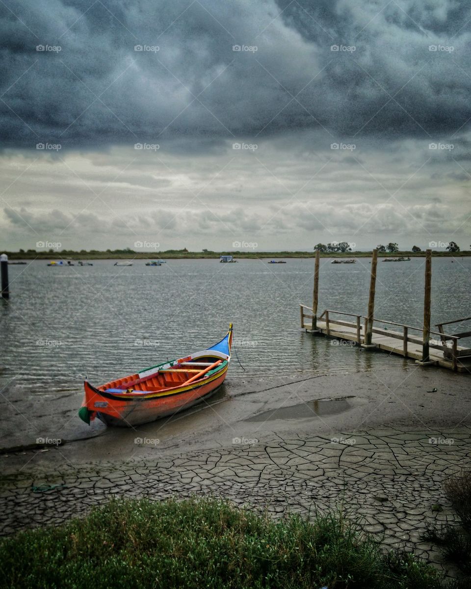 Small fishing boat in a cloudy afternoon 