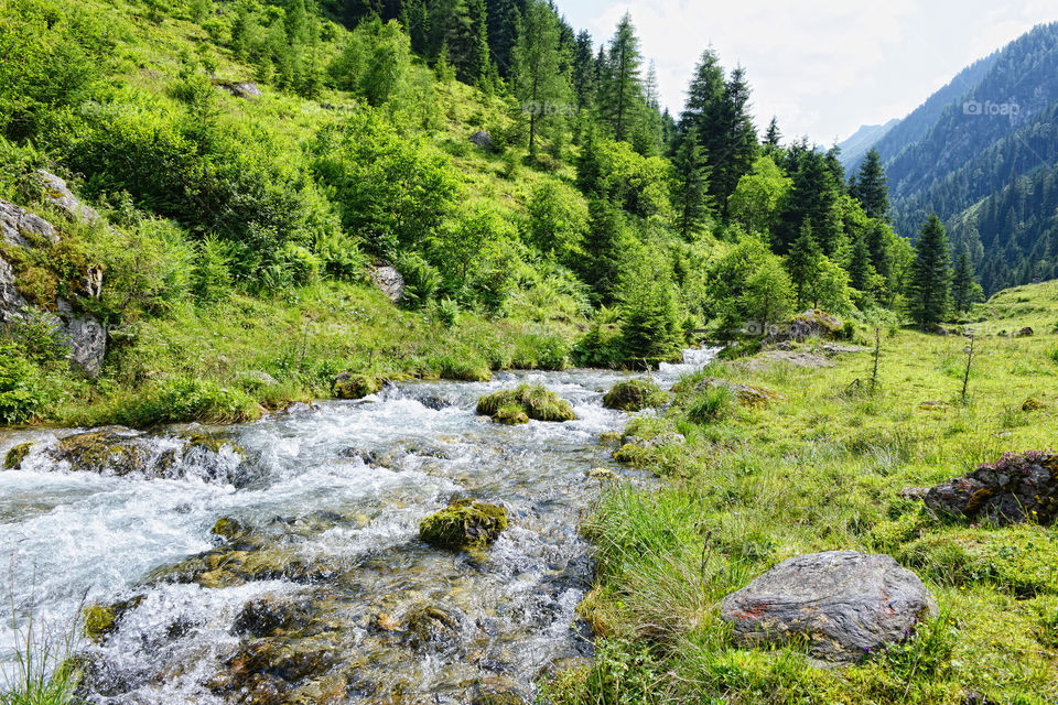 European alps landscape. Stream flowing though Schwarzachtal valley in zillertal alps. Austria.