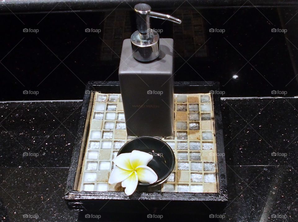 Frangipani flower put in a cup for decoration in washroom