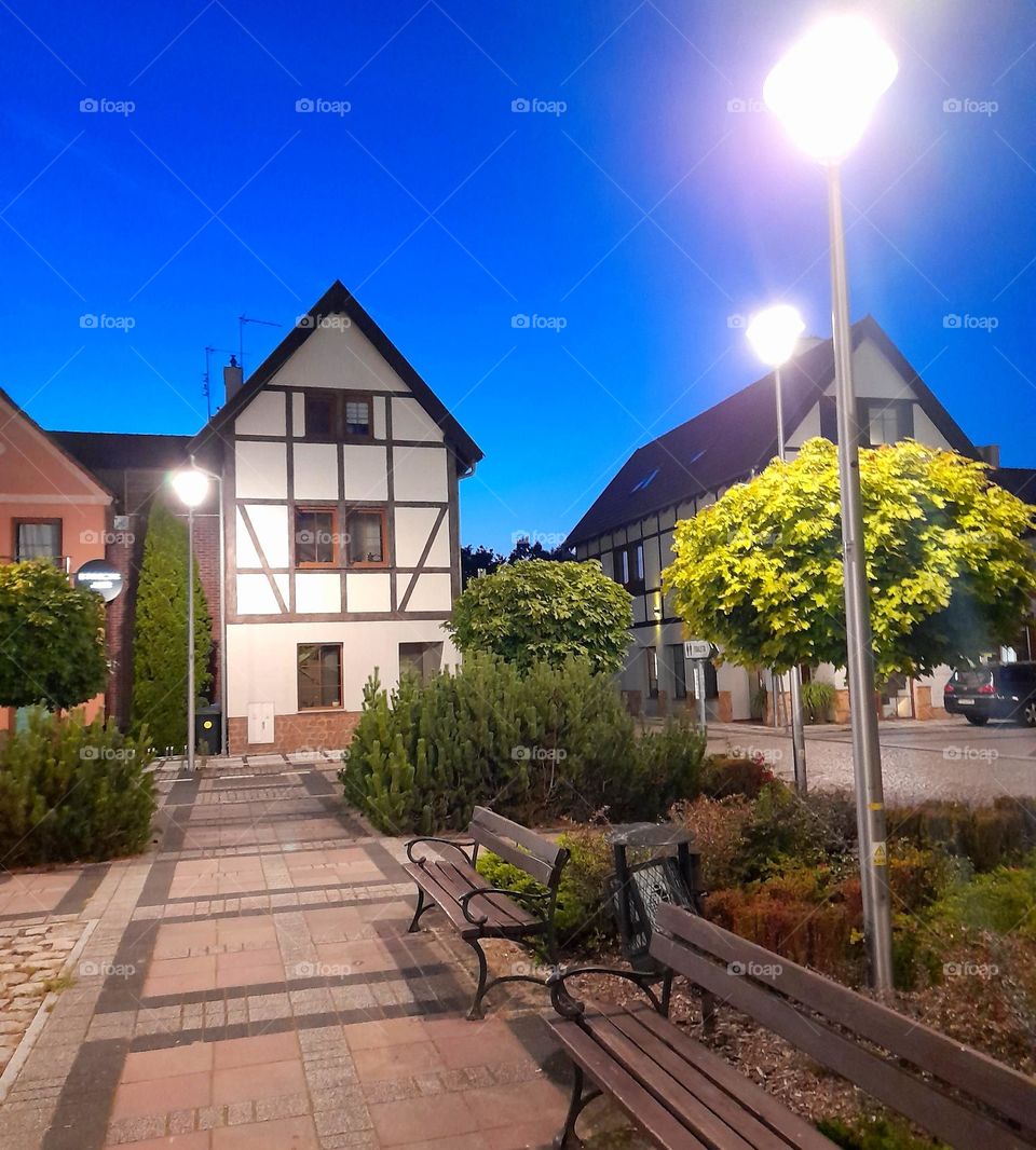 Benches in the foreground and white building in the background.