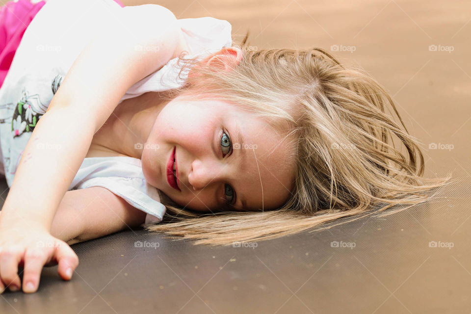beautiful Brianna laying on a trampoline