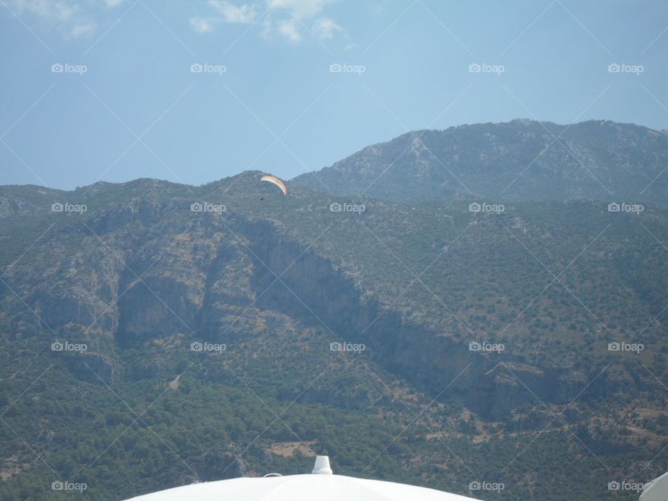 Paraglider by the mountains