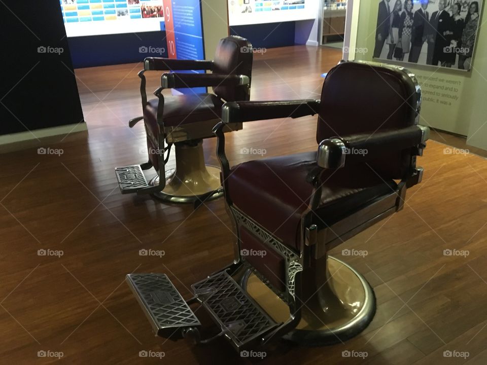 Barber shop chairs the way they once were. Having your beard shaved and hair trimmed.