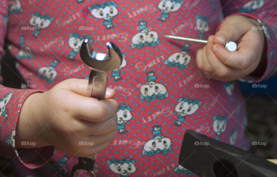 little girl holding tools