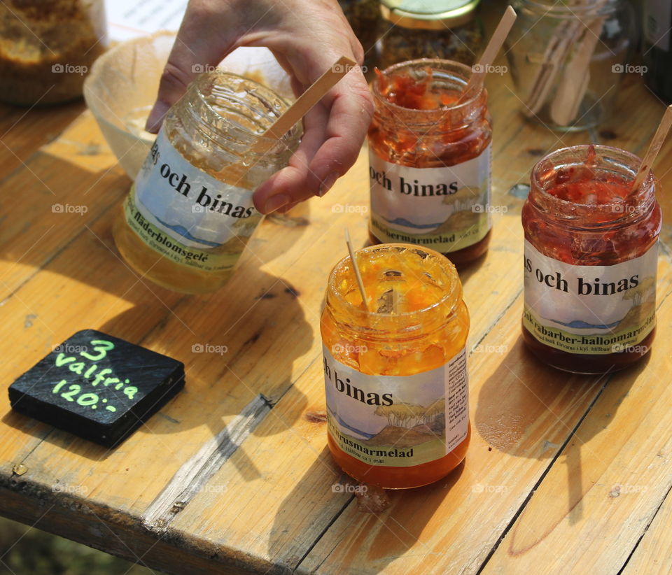 Close-up of hand holding marmalade jar