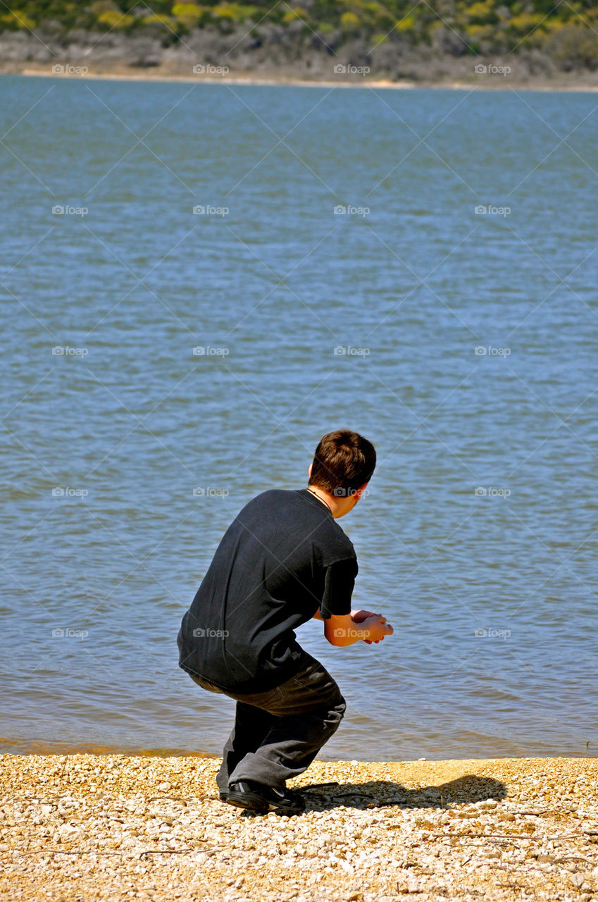 water boy rock throws by refocusphoto