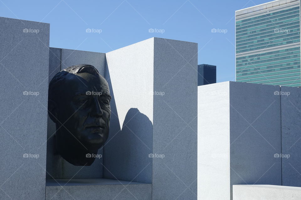 FDR must be rolling in his grave if he knows what Trump is doing to the UN. Foreground is the FDR bust in Four Freedoms Park on Roosevelt island. Background is the UN building in Manhattan. 