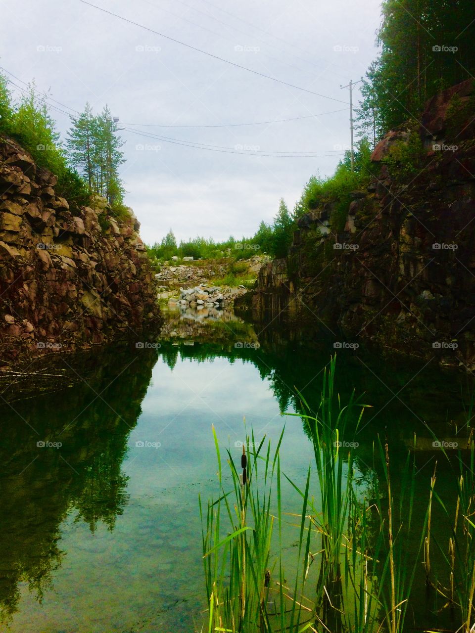 An abandoned stone quarry filled with Green water in Finland
