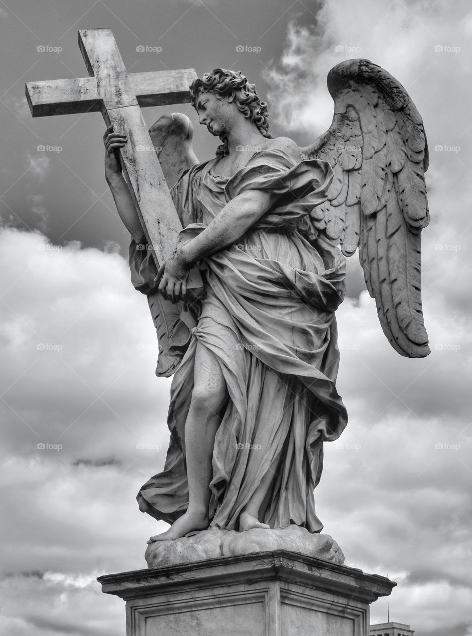Angel statue with the cross on the Sant'Angelo bridge in Rome, Italy