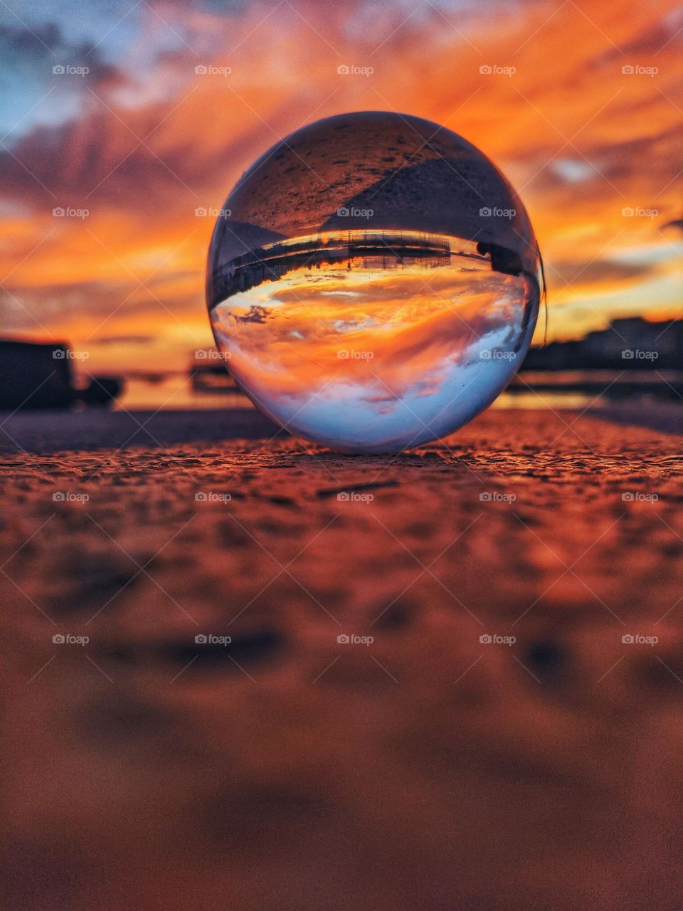 Lensball,  lens ball at the Adriatic sea at red sunset sky close up.