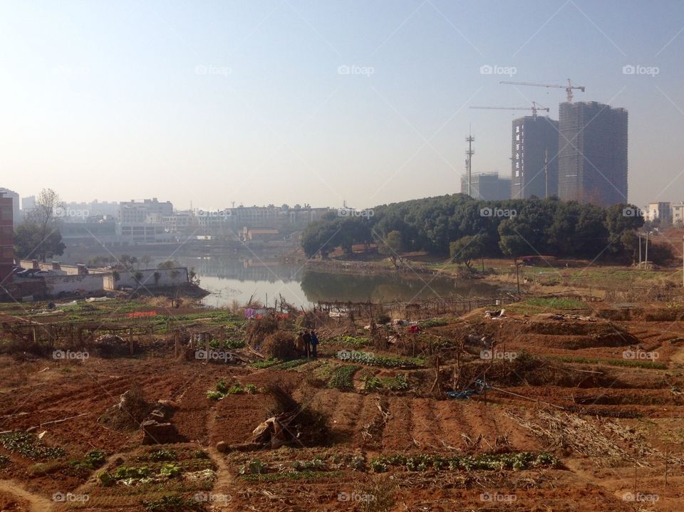 Cityscape of Yiwu poor agricultural districts and a lake