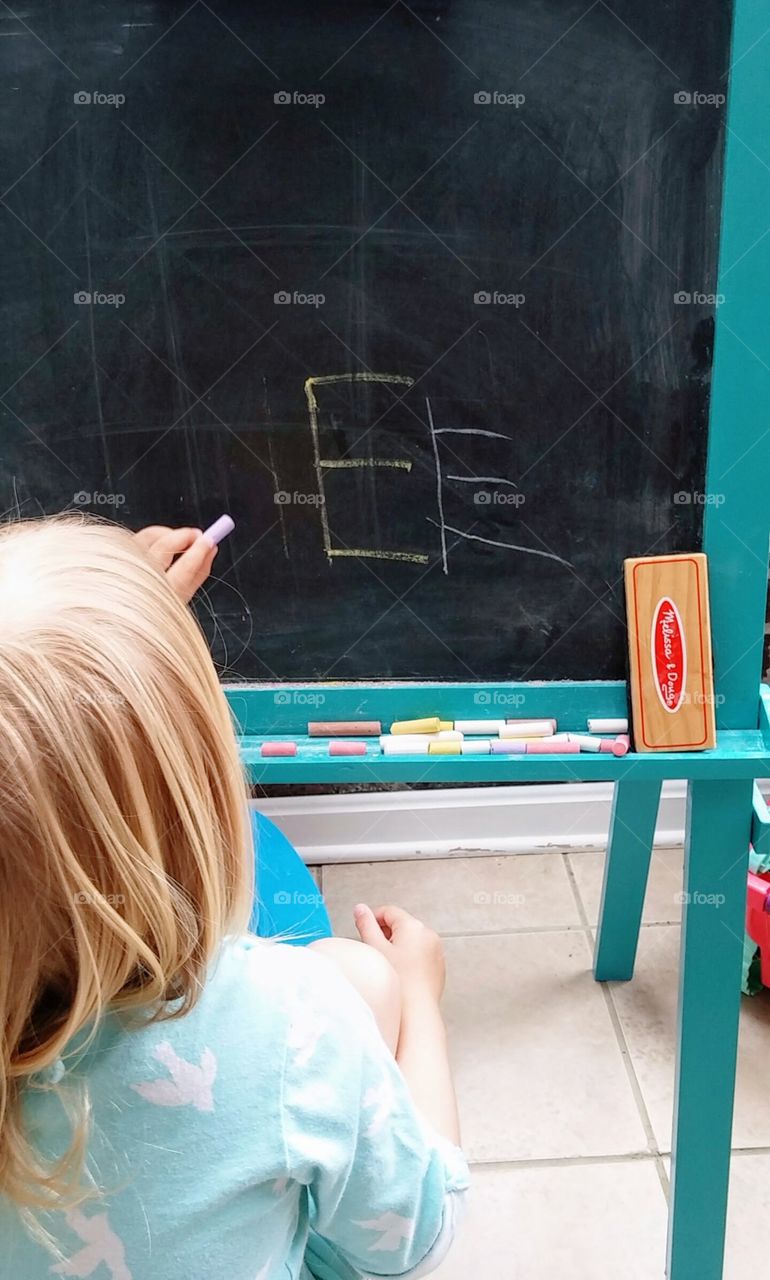 Little Girl Learning with Chalk