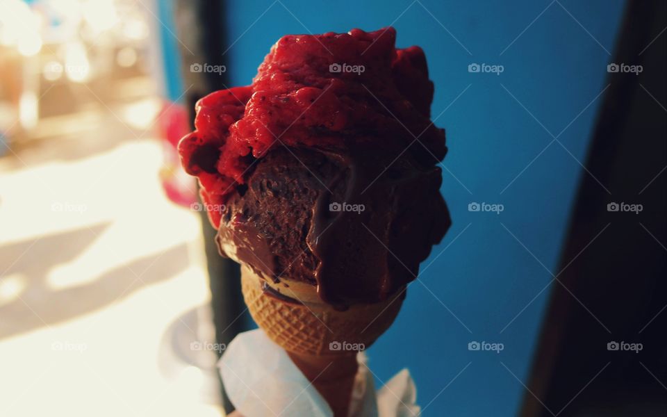 Chocolate cone ice cream with strawberry pulp