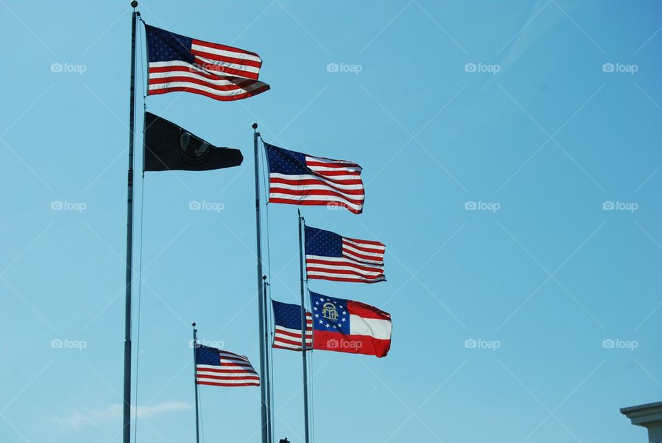 Flags against blue sky