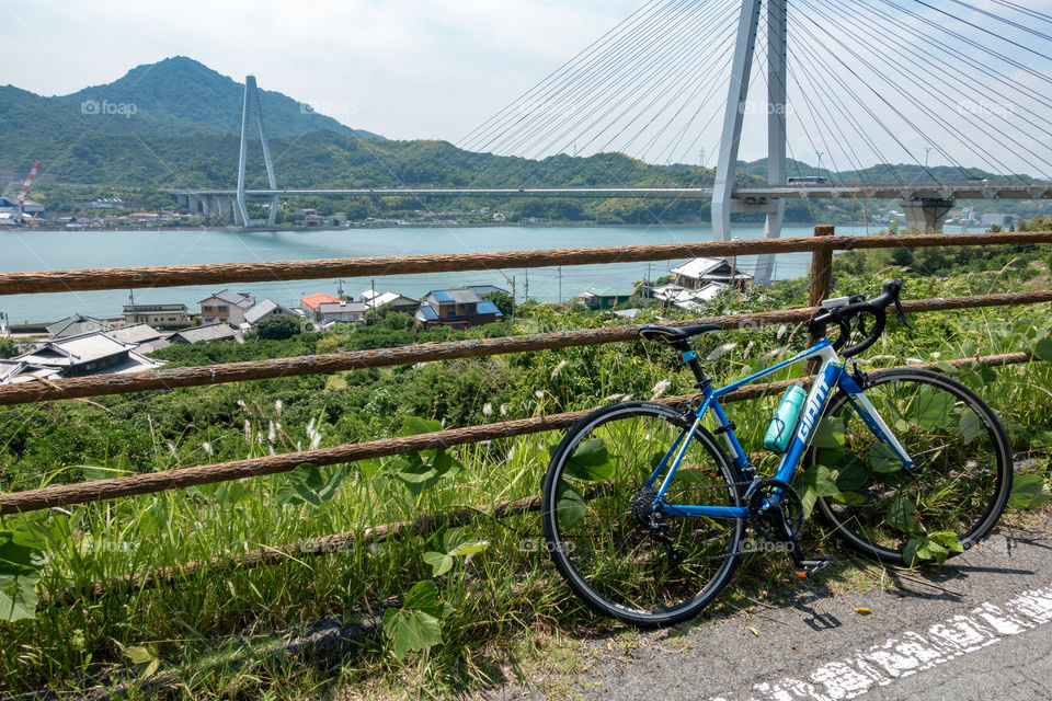 Admiring the verdant hills, cute small town, and sea on the Shimanami Kaido Bikeway; a gorgeous place to rest during my island hopping road bike adventure through Japan. Love my GIANT road bike!