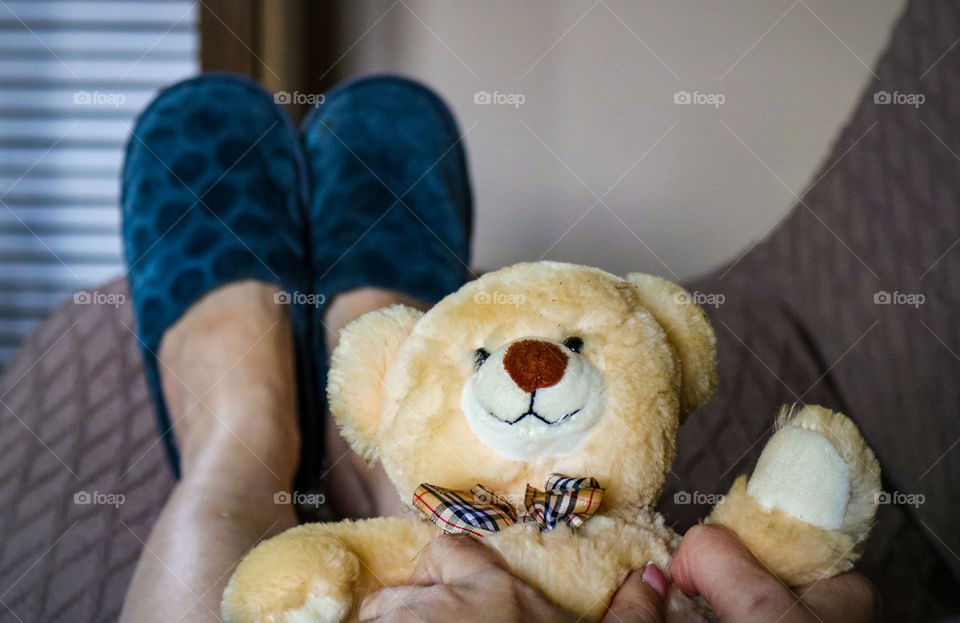 A woman in slippers with teddy bear