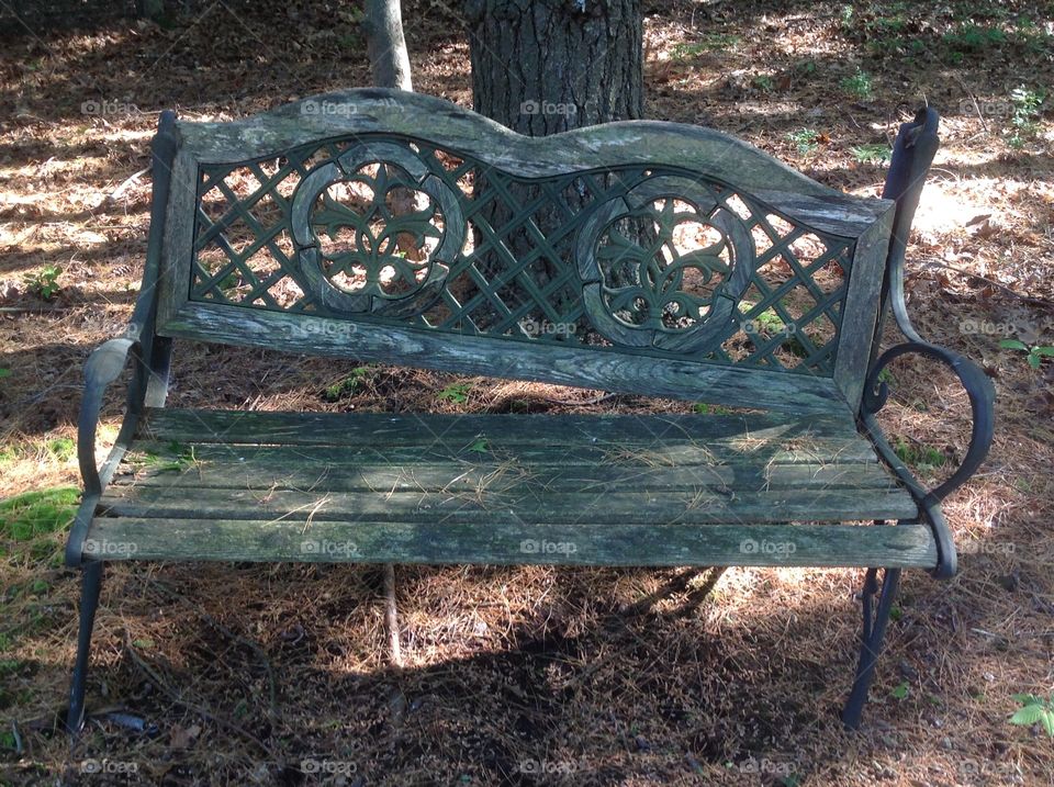 An old weathered broken bench in the yard. 