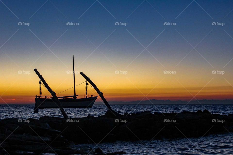 Sunset over the Adriatic Sea. Silhouette of boat.