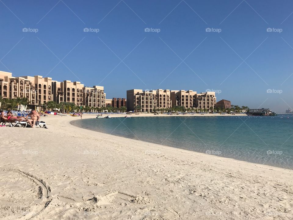 Tourists enjoying the morning sun at the beach resort