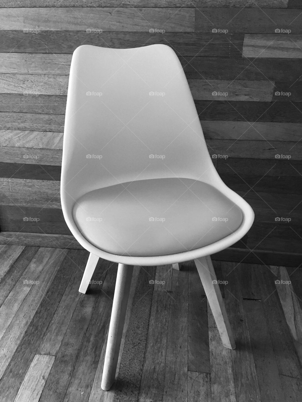 Retro and stylish chair with a vertical and horizontal background. Contrasting textures and shades within the grey scale