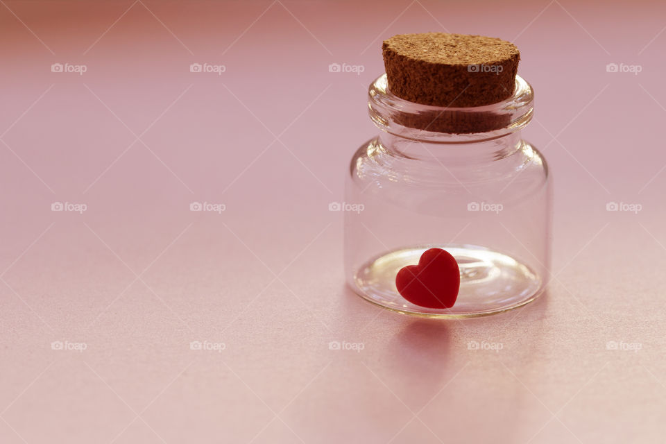 Red heart in the bottle glass