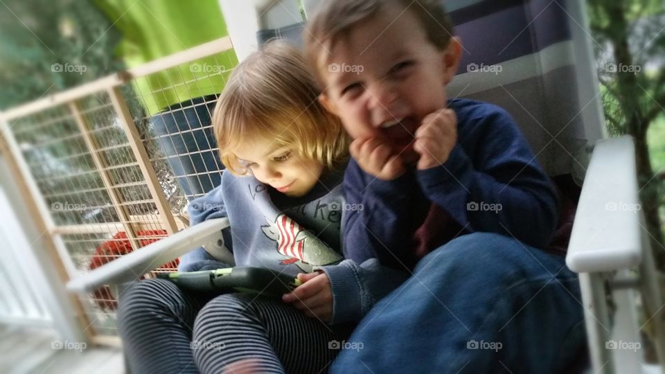 Siblings using tablet