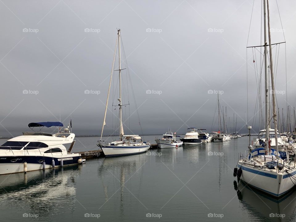 White and blue boats in harbor 